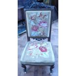 Victorian walnut prayer chair with tapestry seat and back on white porcelain castors.
