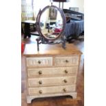 Small oak chest of two short and three long drawers complete with swing frame toilet mirror