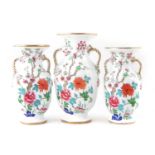 Garniture of three English porcelain vases,