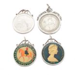 Four silver coin pendants,