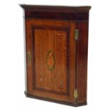 Geroge III oak single door wall hanging corner cabinet cross banded in mahogany.