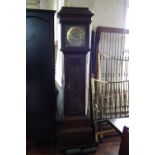 Longcase clock by Wooley with brass dial and carved oak case.