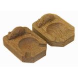 Two Robert "Mouseman" Thompson carved oak ashtrays.