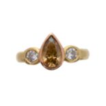 A 'brown' diamond and diamond three stone ring,