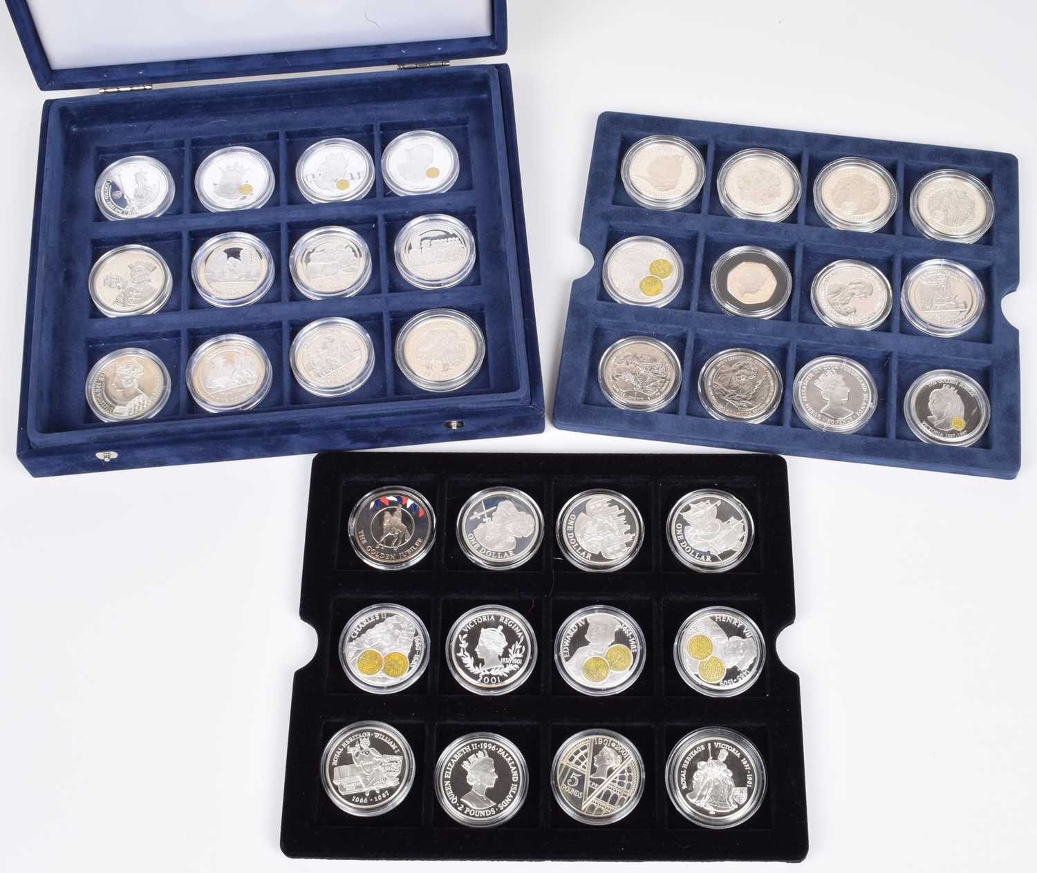 Cased set of 36 silver proof coins to include many commemorative sized crowns, fifty pences etc.