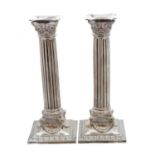 A pair of silver plated candlesticks,