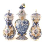 Pair of hexagonal lidded tin glazed vases and one other Delft vase.