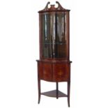 Edwardian mahogany double floor standing serpentine front display cabinet