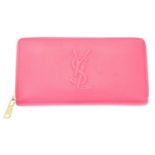 A Yves Saint Laurent zip around logo wallet,