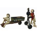 Hustler Toy Corporation tin plate toy wooden figure peddling a tricycle etc.
