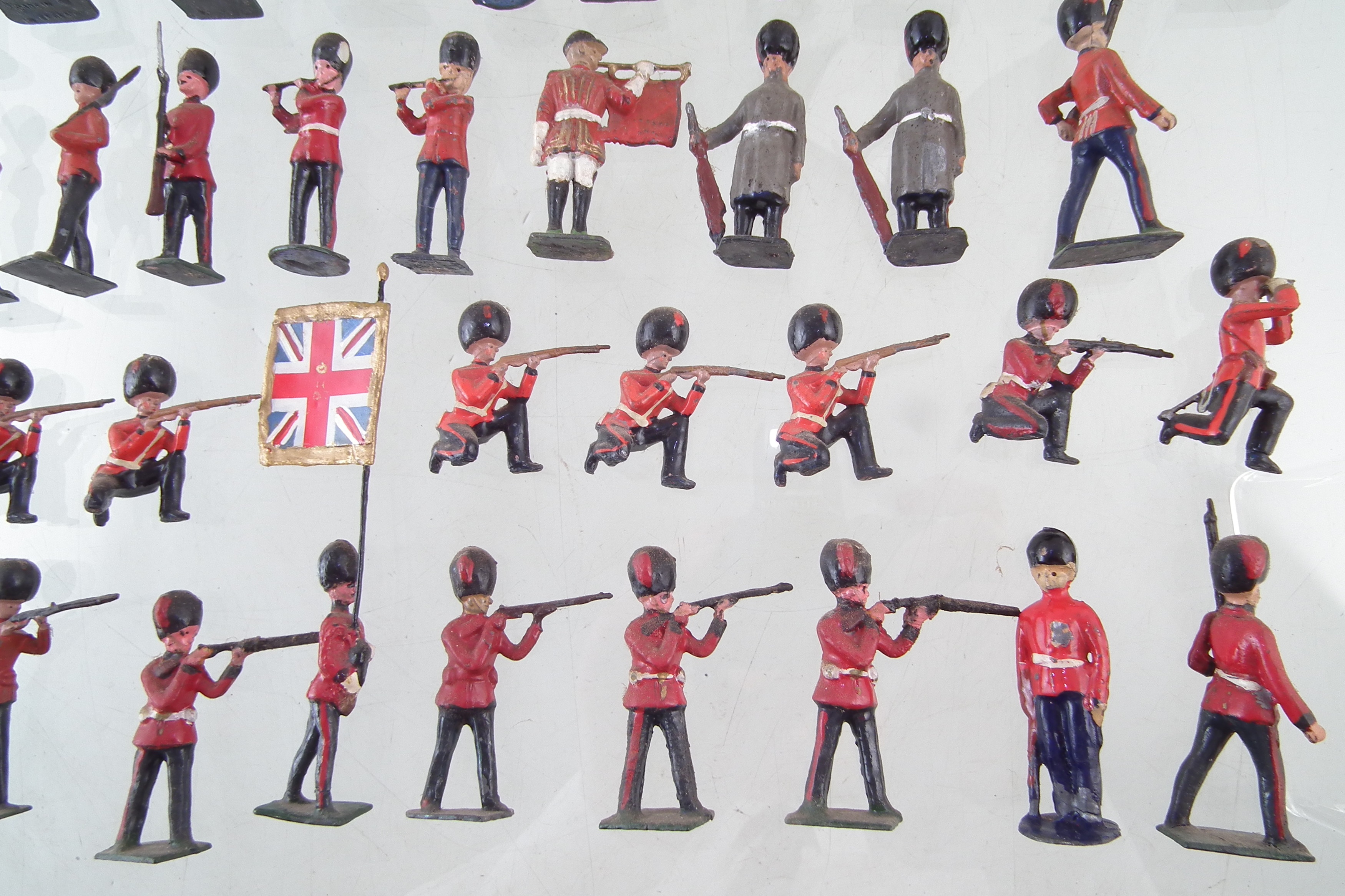 Fifty seven metal British infantry soldiers by J. Hill and Co. and twelve mounted troopers. - Image 3 of 8