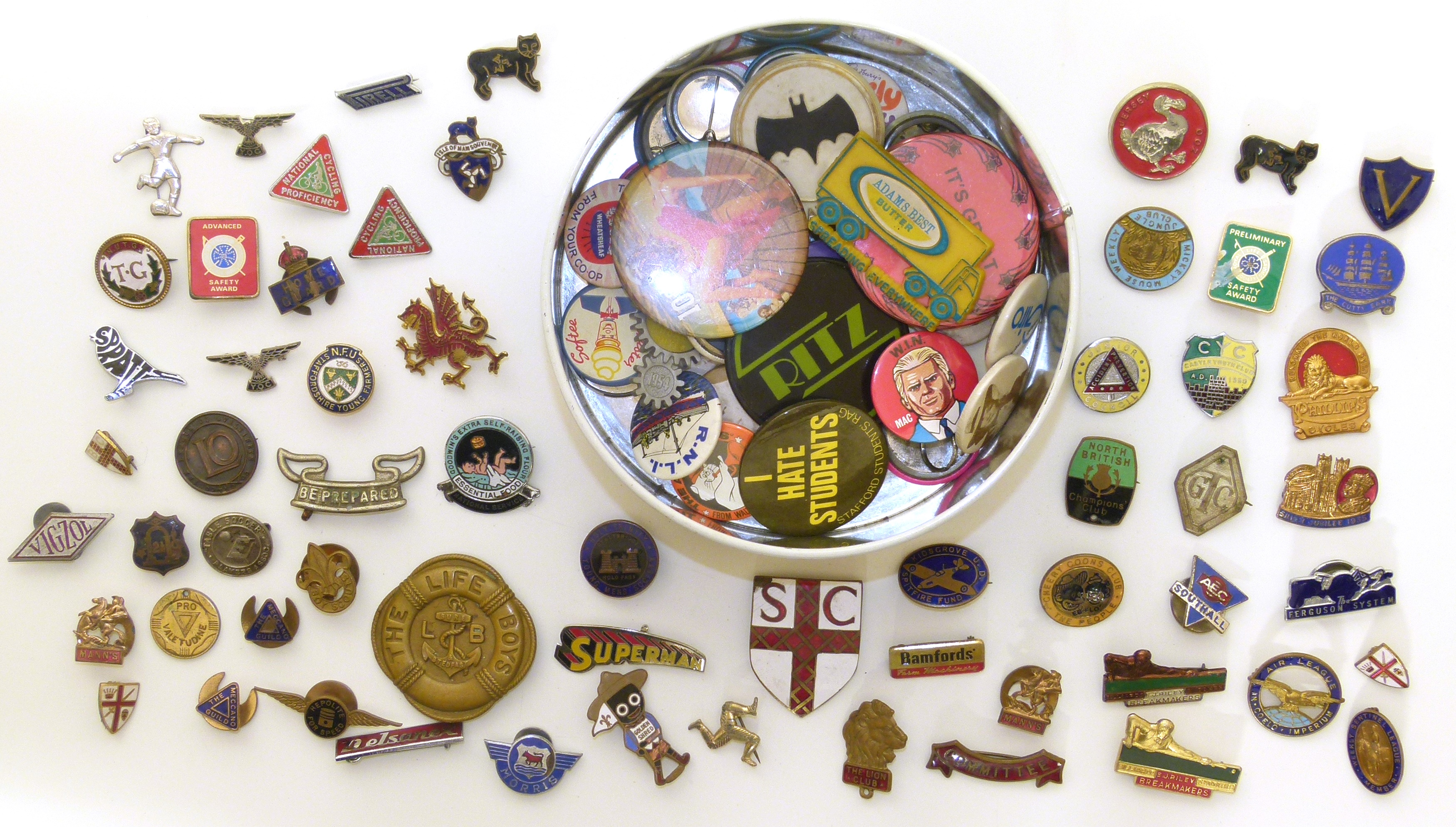 A collection of badges and enamel lapel badges