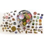 A collection of badges and enamel lapel badges
