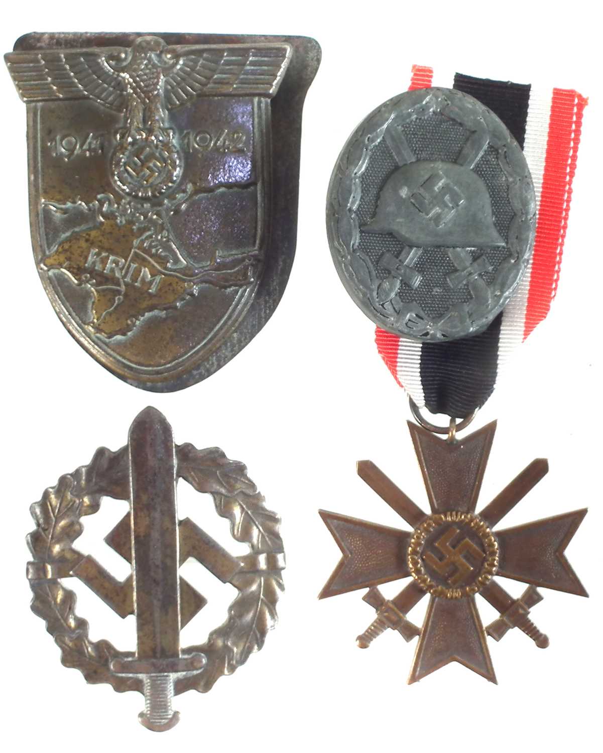 Three German Third Reich badges and a medal
