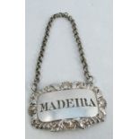 A silver bottle ticket, with shell, leaf and gadrooned edge, pierced Madeira, London 1828, maker