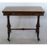 A 19th century walnut fold over games table, of rectangular form, raised on carved and turned