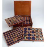 A mahogany coin collectors cabinet, of rectangular form, opening to reveal six trays with circular