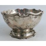 A silver circular bowl, with shaped edge and raised on a shaped foot, Sheffield 1906, weight 6oz,