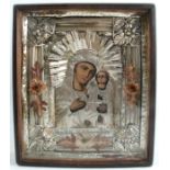 A cased and framed icon, the white metal cover with engraved and raised sections, with cuts for