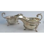 A silver sauce boat, with gadrooned edge, raised on three scroll legs, Birmingham 1922, weight