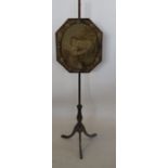 A 19th century mahogany pole screen, the octagonal screen decorated with a tapestry panel of a