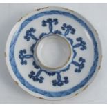 An 18th century Italian maiolica trembleuse saucer, Savona, decorated in blue and white, S and