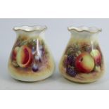 A pair of Royal Worcester vases, decorated half round with fruit by Delaney and Bowkett, shape