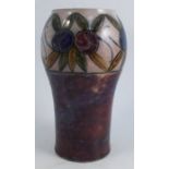 A Royal Doulton stoneware vase, decorated with a band of flowers with mottles purple glaze below,