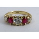 A diamond and ruby five stone ring, stamped '18ct', the three graduated old brilliant cuts totalling