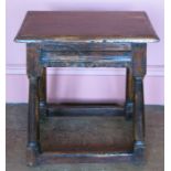 A 17th century style oak joint stool, raised on four turned legs united by a stretcher, width 16ins