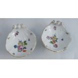 Two 18th century Meissen porcelain shell shaped table salts, on three scroll feet, decorated with