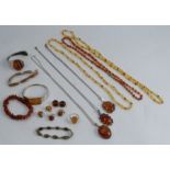 A collection of amber set jewellery, including bangles, pendants and earclips