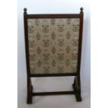 An Edwardian mahogany fire screen, with glazed rectangular panel, having fluted decoration, height