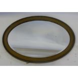 A 19th century oval gilt mirror, having an anthemion border and bevel edge glass