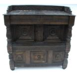 An Antique oak carved sideboard cupboard, the top with carved gallery to the back and sides, with
