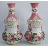 A pair of Victorian porcelain vases, decorated with pink roses and foliage, with pink and gilt