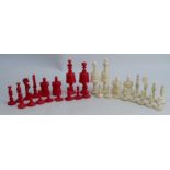 A carved bone chess set, thirty-two pieces, some pieces stained red, height of king 3.25ins
