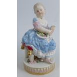 A 19th century Meissen porcelain figure, of a seated woman holding an open book and flowers in her