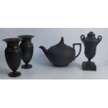 A collection of 19th century Wedgwood black basalt, to include a pair of vases, a covered urn and