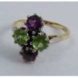 A four stone amethyst and peridot dress ring, stamped '18ct & Plat', finger size P, 5g gross