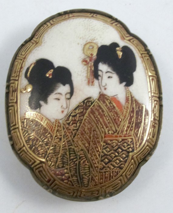 A Satsuma pottery plaque, mounted for a buckle, Meiji period, decorated with two portraits of
