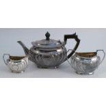 A silver three piece tea set, with wrythern fluting and floral decoration, Sheffield 1965, weight