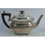 A silver tea pot, with gadrooned decoration, bearing a presentation inscription, Birmingham 1913,