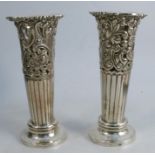 A pair of silver trumpet vases, with upper section with pierced and embossed flower and scroll