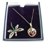 A 9 carat gold three stone ruby pendant on chain, together with a stone set dragonfly pendant,