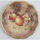 A Royal Worcester cabinet plate, decorated with fruit to a mossy background by Sibley Lewis,