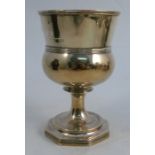 A Georgian silver standing cup, with ribbed decoration raised on a pedestal with octagonal foot,