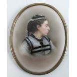 A 19th century oval porcelain plaque, decorated with a portrait of a woman wearing black and