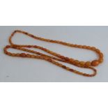 A row of graduated oval amber beads, together with another row of smaller graduated amber beads,