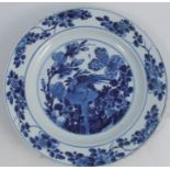 A Chinese Kangxi dish, decorated in blue and white with a bird and foliage, leaf mark to